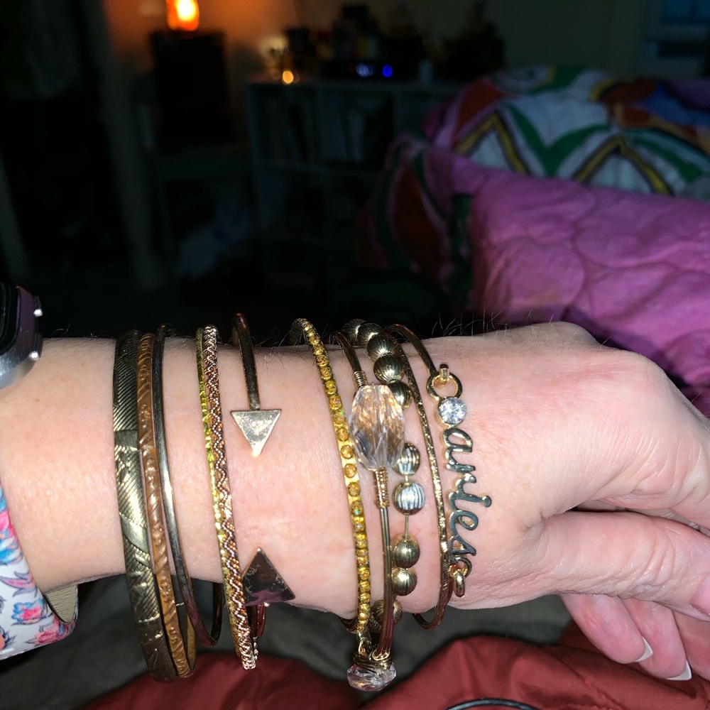 11 (eleven) gold tone bracelets.